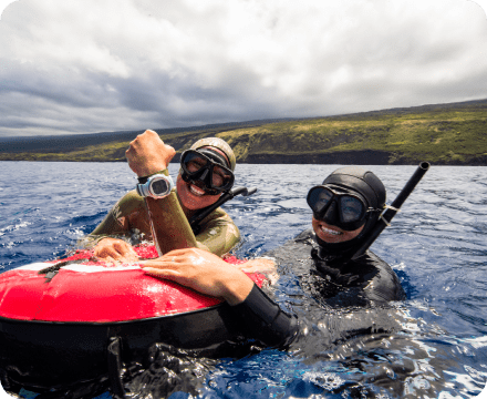 two smiling divers over water